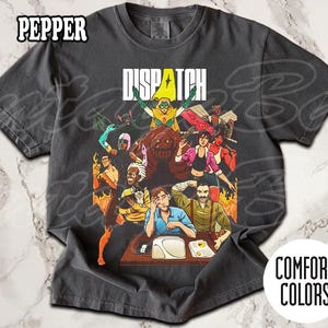 May include: Dark grey t-shirt with a graphic featuring the word "DISPATCH" above a group of cartoon characters. The shirt is labelled "COMFORT COLORS" and "PEPPER".