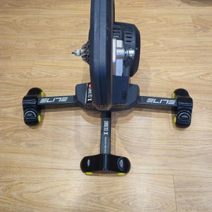 May include: Black indoor cycling trainer with a black and yellow base and the text "ELITE DIRETO X" printed on the side.