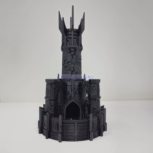 May include: A black 3D printed tower with a pointed roof and a stone-like texture. The tower has a small opening at the base.