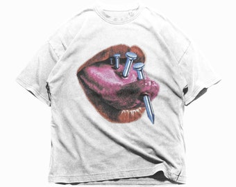 May include: White t-shirt with a graphic of a mouth with a tongue sticking out and nails piercing through it.