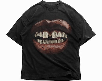May include: Black t-shirt with a graphic of a large mouth with gold teeth.
