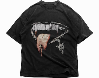 May include: Black t-shirt with a graphic print of a mouth with fangs and a tongue sticking out. The mouth is surrounded by a zipper and a small pendant hangs from the zipper.