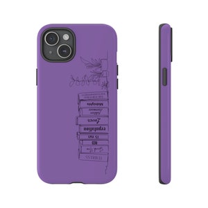 May include: Purple phone case with a black line drawing of a stack of books and a plant on the back. The book titles include "Fearless", "Speak Now", "Red", "1989", "reputation", "Lover", "folklore", "evermore", "Midnights", "The Tortured Poet's Department".