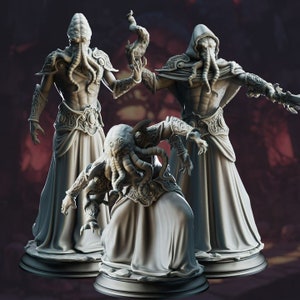 May include: Three gray, detailed, sculpted figures of humanoid creatures with tentacles on their heads. The figures are wearing robes and are posed in different stances.