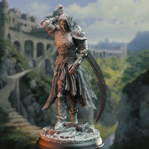 May include: A detailed figurine of a warrior in full armour, holding a sword. The warrior has long, flowing hair and a serious expression. The figurine is set on a rocky base and is painted in shades of grey and silver.