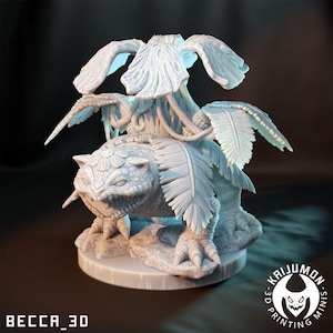May include: A detailed, light-colored 3D-printed miniature of a fantasy creature. The creature has a turtle-like body, a reptilian head, and large, feathery wings. The base is round, and the text "BECCA_3D" and "KAIJUMON MINIS" are visible.