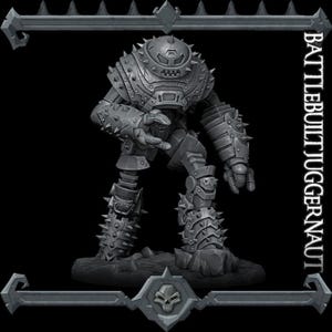May include: A grey, detailed, 3D printed miniature of a heavily armoured robot, standing on a rocky base. The robot has a large, round head with a faceted design and a spiked body. The miniature is labelled "BATTLEBUILT JUGGERNAUT".