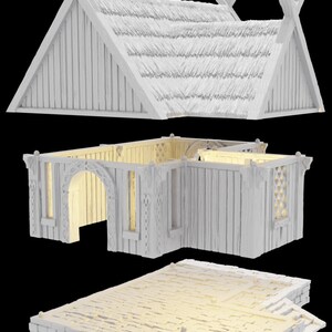 Op de afbeelding: Een wit, driedelig, miniatuurmodel van een Viking-lang huis met een rieten dak, houten muren en een stenen fundering. Het model is gedemonteerd, waardoor de afzonderlijke onderdelen zichtbaar zijn.
