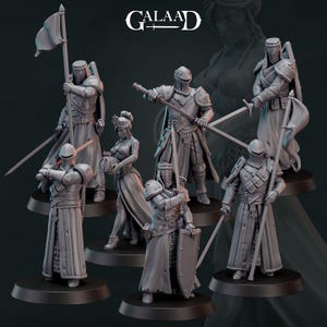 May include: A collection of gray miniature figurines depicting medieval knights and a woman. The knights are armored and armed with swords, shields, and flags. The figurines are on black bases, with the word "GALAAD" at the top.