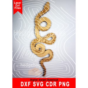 May include: A laser cut file of a snake with a decorative pattern. The file is available in DXF, SVG, CDR, and PNG formats.