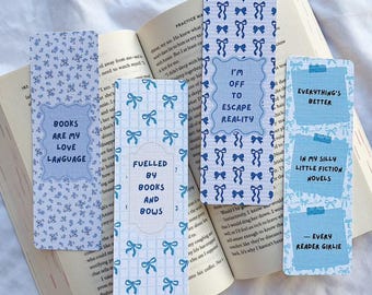 May include: Set of six blue and white patterned bookmarks with inspirational quotes. The quotes include "Books are my love language", "Fuelled by books and bows", "I'm off to escape reality", "Everything's better", "In my silly little fiction novels", and "Every reader girlie".