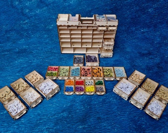 May include: A wooden organizer with multiple compartments for storing small game pieces. The organizer is filled with colorful game pieces, including red, blue, green, yellow, and white. The organizer is made of wood and has a natural finish.