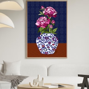 May include: A framed wall art print featuring a white and blue ceramic vase with a floral pattern, filled with vibrant pink peony flowers and green leaves. The background consists of a dark blue patterned wall and a solid brown surface.