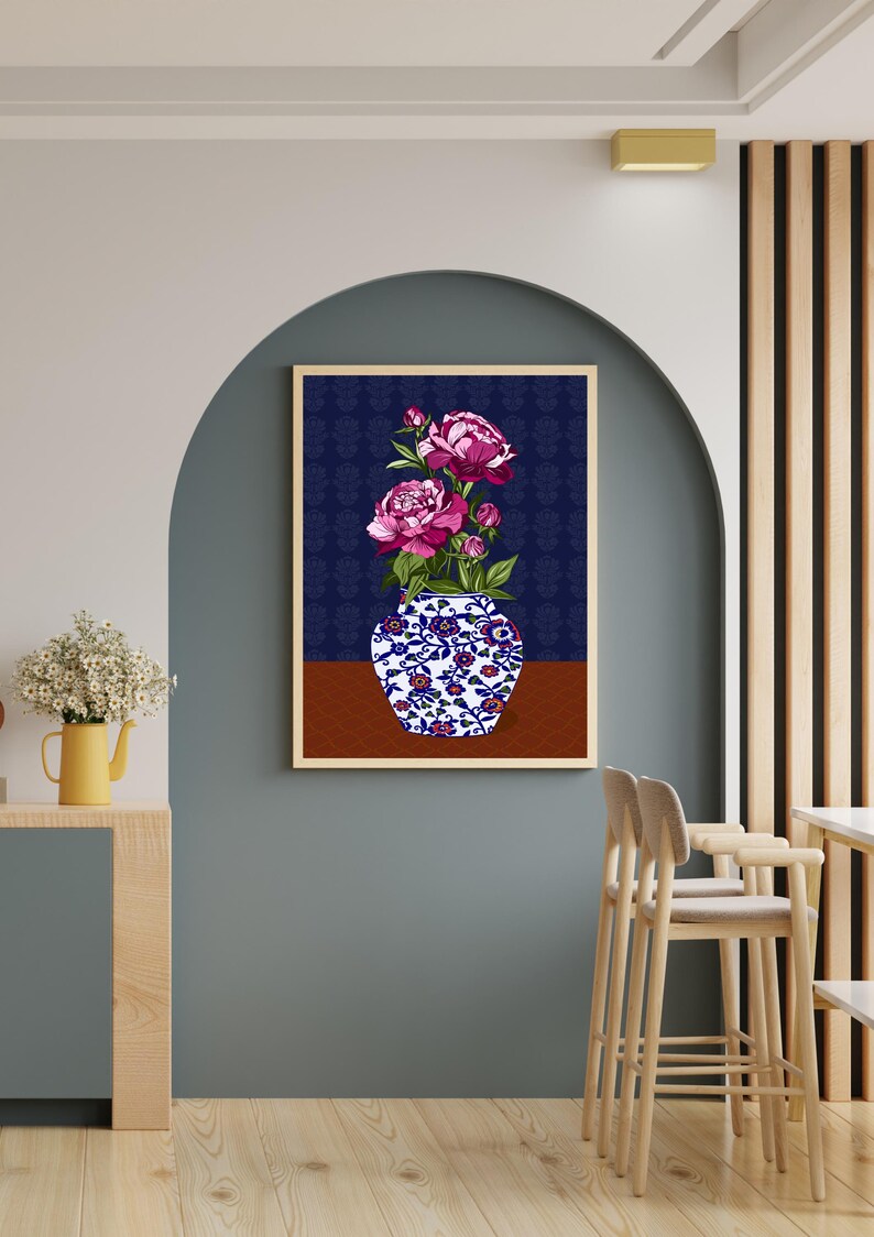 May include: A framed wall art print featuring a blue and white porcelain vase with intricate floral patterns, holding a bouquet of vibrant pink peony flowers. The background of the artwork is a deep navy blue with a subtle repeating pattern.