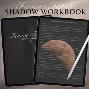 May include: Two black tablets with the text "Femme Fatale Shadow Workbook". One tablet displays a workbook page with text and a moon graphic. A white stylus rests on the screen. The workbook covers shadow work practices and exercises.