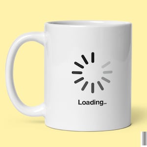 May include: White ceramic mug with a black and gray loading icon and the text "Loading..." printed on it.