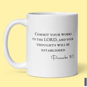 May include: White ceramic mug with a black quote that reads "Commit your works to the Lord, and your thoughts will be established." The quote is attributed to Proverbs 16:3.