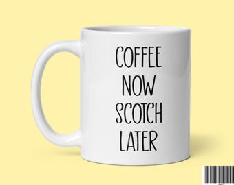 May include: White ceramic coffee mug with black text that reads "Coffee Now Scotch Later".
