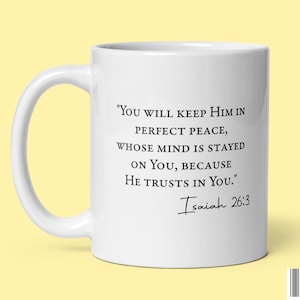 May include: White ceramic mug with a black quote that reads "YOU WILL KEEP HIM IN PERFECT PEACE, WHOSE MIND IS STAYED ON YOU, BECAUSE HE TRUSTS IN YOU."  The quote is attributed to Isaiah 26:3.