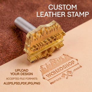May include: A custom leather stamp with a brass head and a silver handle. The stamp is shown on a piece of tan leather with an embossed design. Text on the image reads "CUSTOM LEATHER STAMP" and "UPLOAD YOUR DESIGN".