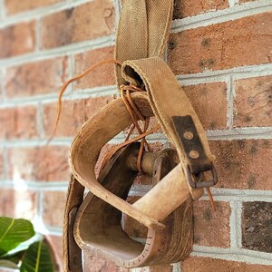 Antique Wooden Mismatched Stirrups with belt/strap and rawhide string. Amazing Rustic Country/Western/Farmhouse Style wall or table decor