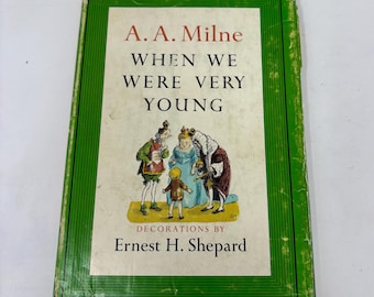 May include: A green hardcover book titled "When We Were Very Young" by A.A. Milne with illustrations by Ernest H. Shepard.