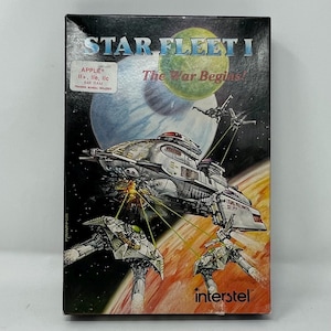 May include: Boxed game cartridge for Star Fleet I, a space-themed game for Apple II+, Ile, and IIc computers. The box features a colorful illustration of a spaceship in space with other smaller ships and planets in the background. The text on the box reads "Star Fleet I The War Begins!" and "interstel".