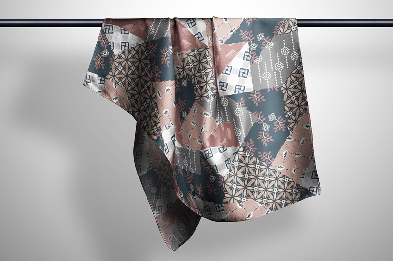 May include: A square scarf featuring a patchwork design with various geometric and floral patterns in shades of dusty rose, slate blue, white, and charcoal gray. The fabric displays repeating motifs including small circles, leaves, and squares.