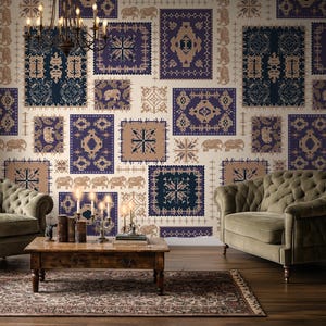 May include: A room with patterned wallpaper in navy, tan, and cream square designs. Two olive green tufted armchairs and a wooden coffee table with a rug. A chandelier hangs above the coffee table, enhancing the room's decor.