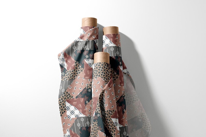 May include: Three vertical rolls of fabric featuring a patchwork design in shades of dusty rose, dark charcoal, and white. The pattern consists of various geometric shapes, floral motifs, and small repeating symbols printed across the textile surface.