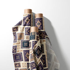 May include: Three rolls of patterned fabric with a repeating design of squares in navy blue, beige, and brown. The fabric features geometric and elephant motifs. The rolls are on a white background.