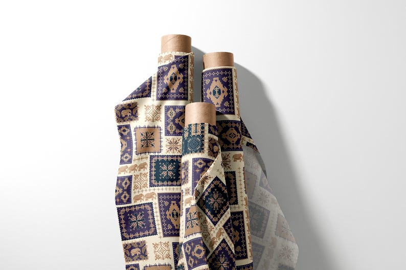 May include: Three rolls of patterned fabric with a repeating design of squares in navy blue, beige, and brown. The fabric features geometric and elephant motifs. The rolls are on a white background.