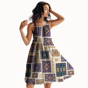 May include: A sleeveless dress with a patchwork design featuring squares in shades of purple, tan, and blue. The dress has a flared skirt and a scoop neckline. The pattern includes geometric and animal motifs.