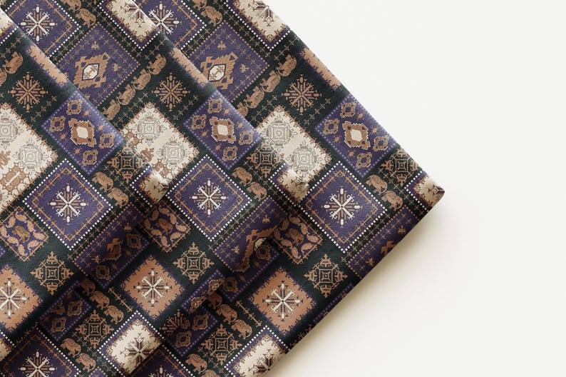 May include: Folded fabric with a repeating geometric pattern in shades of purple, brown, and beige. The design features squares with intricate details, creating a textured appearance. The fabric appears to be woven.