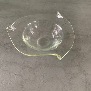 A vintage bowl in triangle shape made of clear glass