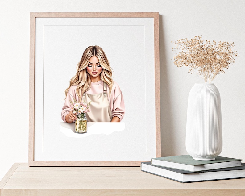 May include: A framed art print featuring a woman with long blonde hair, wearing a pink sweater and a light pink apron. She is holding a mason jar filled with flowers. A white vase with dried flowers sits nearby.