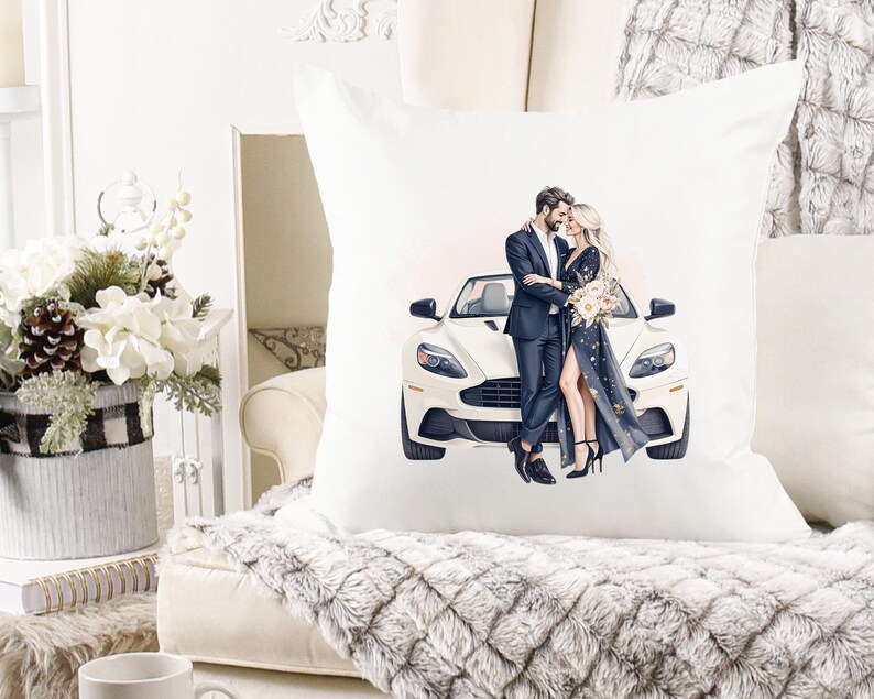 May include: Square white cushion with an illustration of a couple and a white sports car. The man is in a dark suit, and the woman wears a long, dark dress. The cushion is on a cream-coloured sofa with a faux fur throw.
