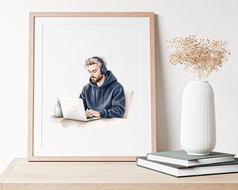 May include: A framed watercolour print shows a person in a blue hoodie and headphones using a laptop. A small vase and pen holder are on the desk. The print is on a wooden table, with a white vase and books in the background.