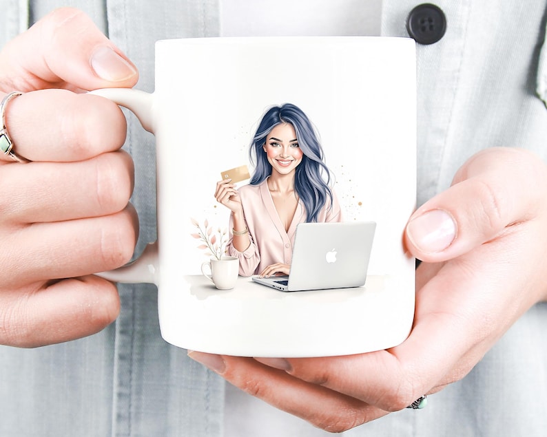 May include: White ceramic mug with a watercolour illustration of a woman with blue hair holding a credit card and using a laptop. A small cup and floral arrangement are also depicted. The mug is held by a person.