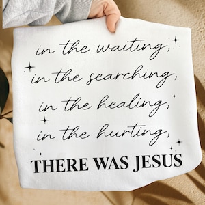 May include: A white blanket with black script that reads "in the waiting, in the searching, in the healing, in the hurting, THERE WAS JESUS." The text is in a cursive font with small star accents.