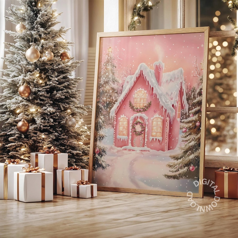 May include: A framed print of a pink gingerbread house in a snowy winter scene. The artwork features a house with snow-covered roof and a wreath on the door. A Christmas tree with ornaments and wrapped gifts are in the foreground.