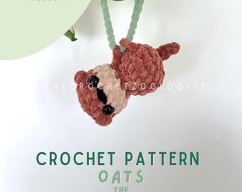 May include: A crocheted otter charm in shades of brown and cream, designed as a car, bag, and key charm. The text "CAR, BAG & KEY CHARM PAL" is displayed on the left, and "CROCHET PATTERN OATS THE OTTER" is at the bottom.