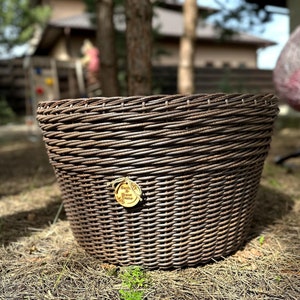 May include: A brown wicker planter with a round wooden tag that says "Garden & Home Decor".