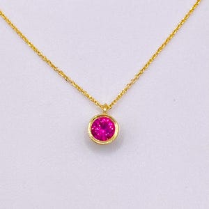 9k gold pendant with red zircon stone