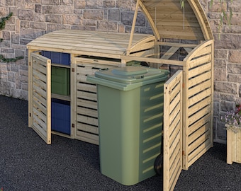 Può includere: Un'unità di stoccaggio esterna in legno con un design a doghe. L'unità ha un coperchio e porte incernierate e ospita un bidone della spazzatura verde e contenitori di stoccaggio blu e verdi. La struttura è in legno chiaro ed è posta contro un muro di mattoni.