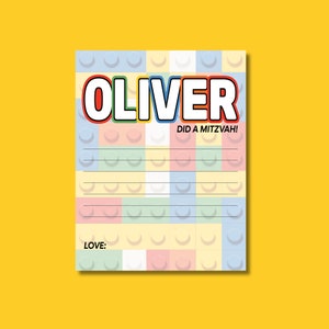 May include: A colorful card with a Lego-like pattern. The card says "Oliver Did A Mitzvah!" and has a space for writing "Love:"