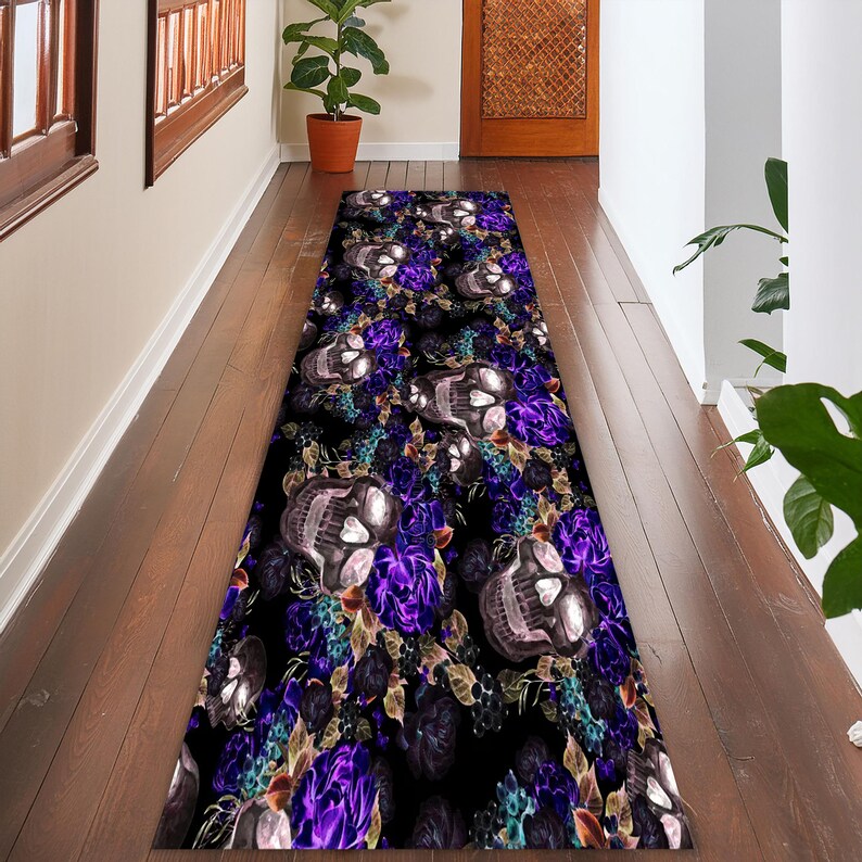 May include: A black and purple runner rug with a skull and floral pattern. The rug features a repeating pattern of skulls with purple flowers and leaves.