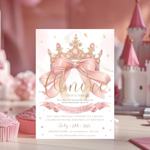 May include: A pink and gold princess-themed invitation for a first birthday. The invitation features a large pink bow, a golden crown, and the words "Once Upon a Time." The text reads "Princess Adeline" and the date "July 27th, 2025."