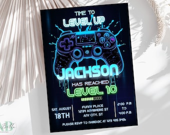 May include: A black invitation with a neon blue and green video game controller design. The text reads "Time to Level Up" and "Jackson has reached Level 10". Includes event details: date, time, and RSVP information.