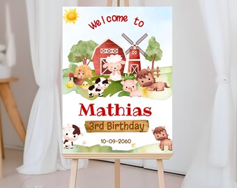 Pode incluir: Bem-vindo ao 3º aniversário do Mathias, sinal com uma ilustração em aquarela de um celeiro vermelho, um moinho de vento e animais de fazenda. O sinal está em um cavalete de madeira.